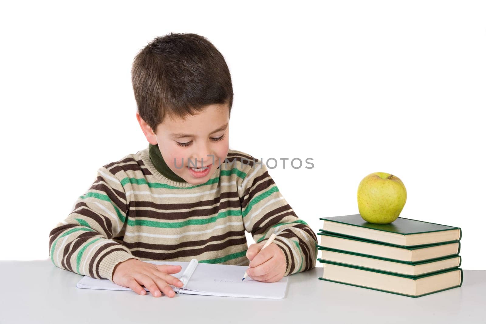 Adorable child writing in the school