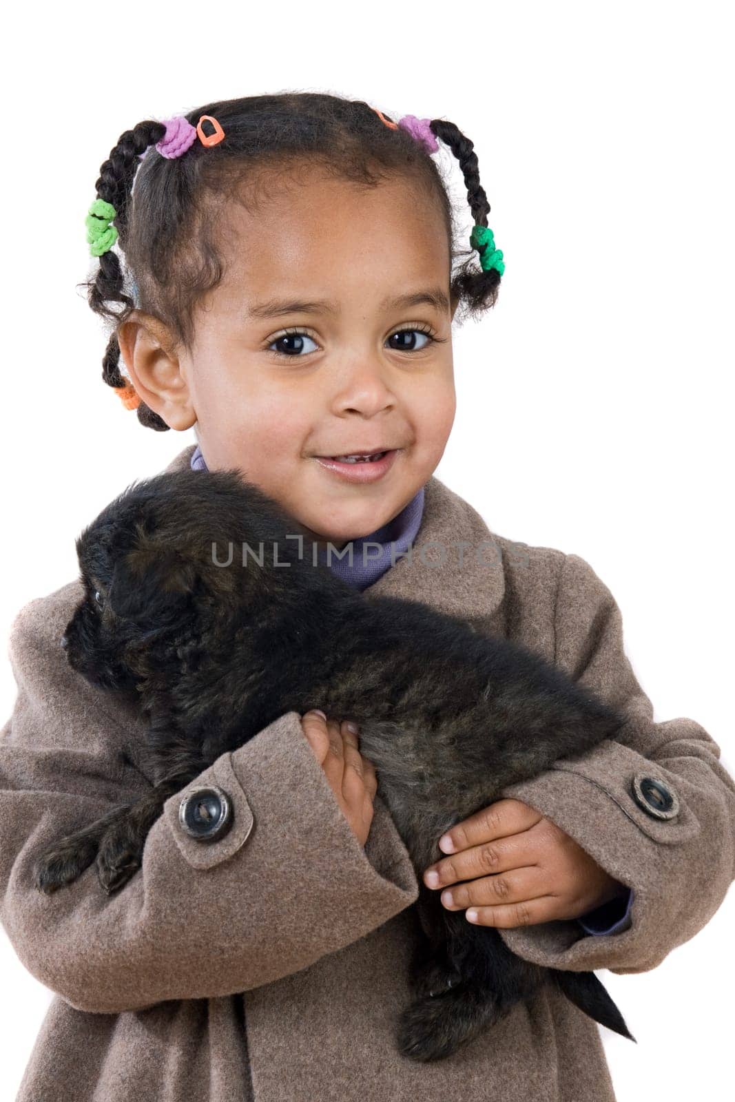 African baby holding a puppy on her arms