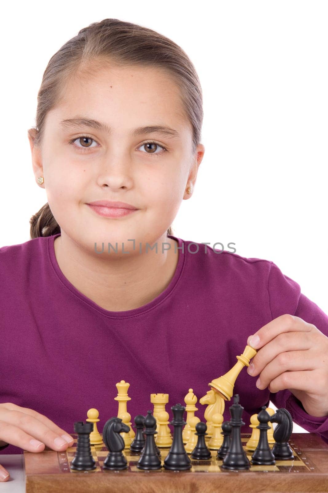 Attractive little girl playing chess