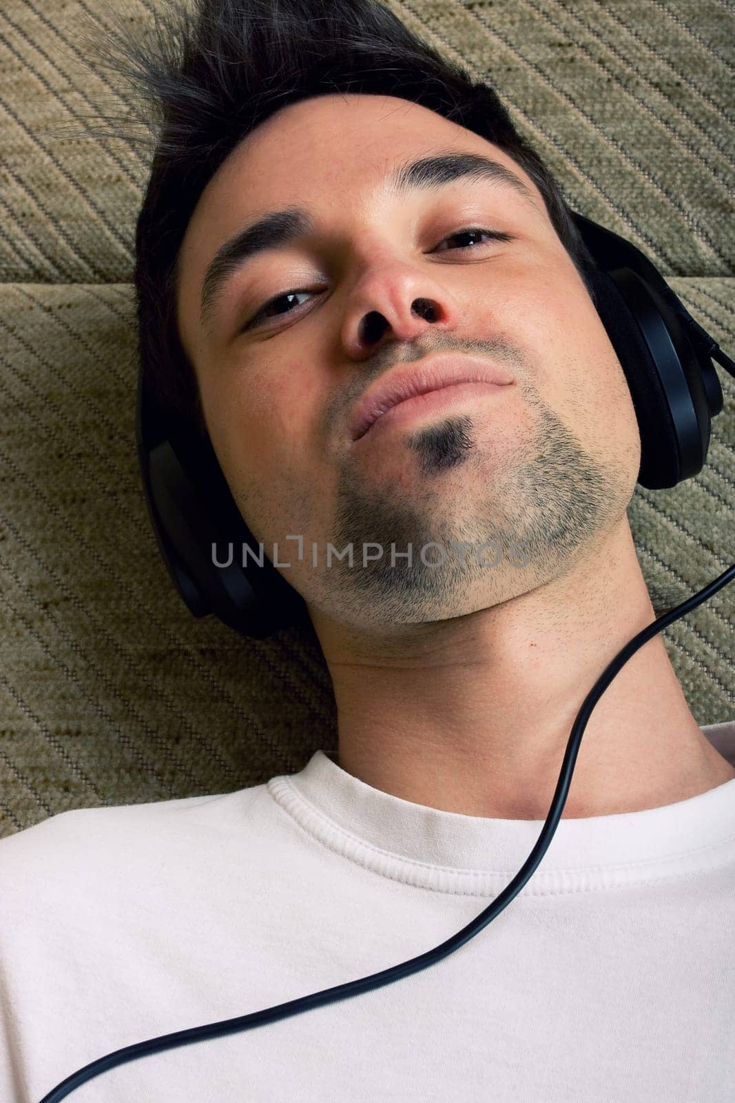 Laying young man listening music