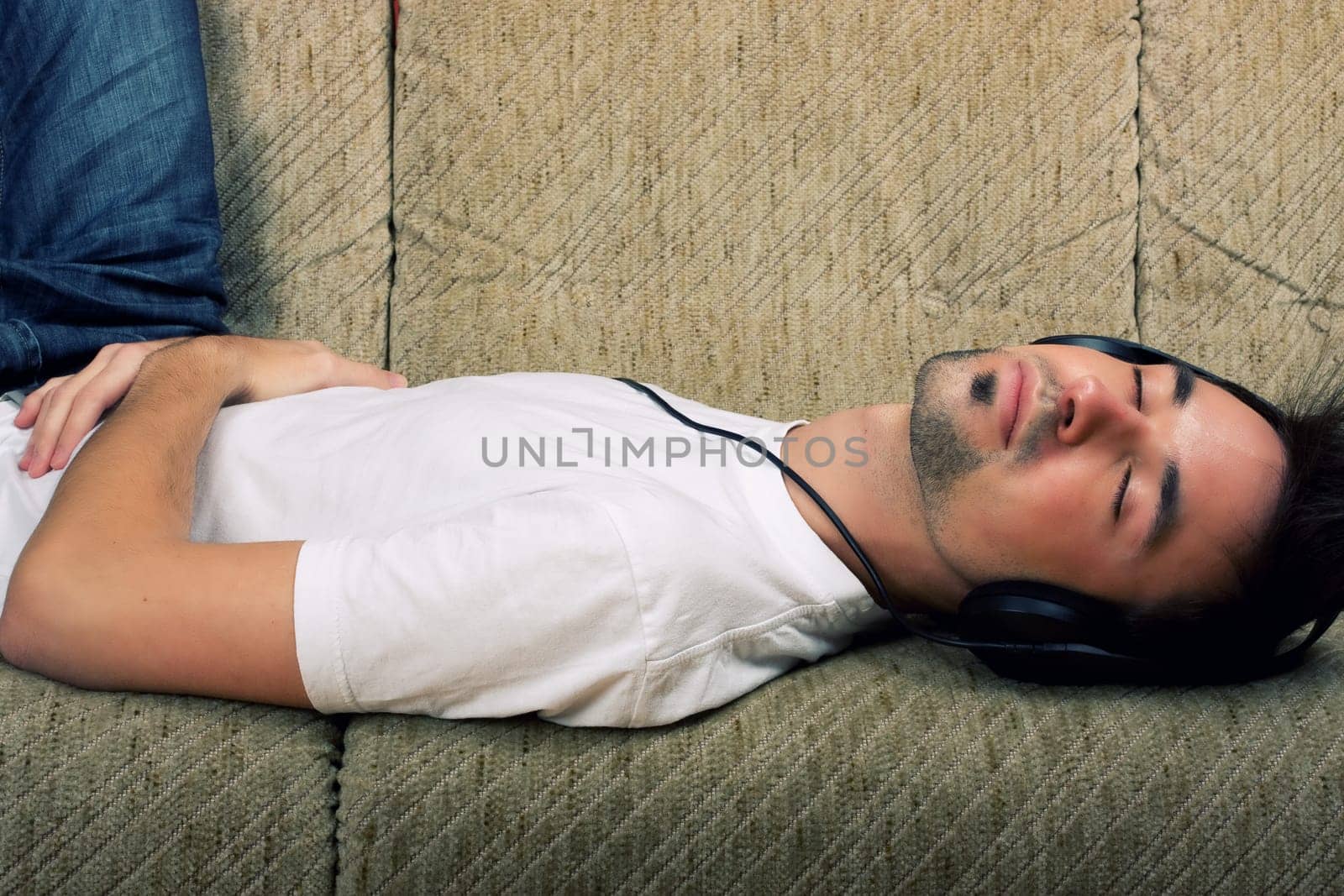 Laying young man listening music