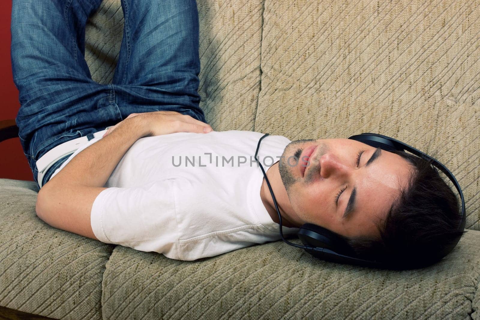 Laying young man listening music
