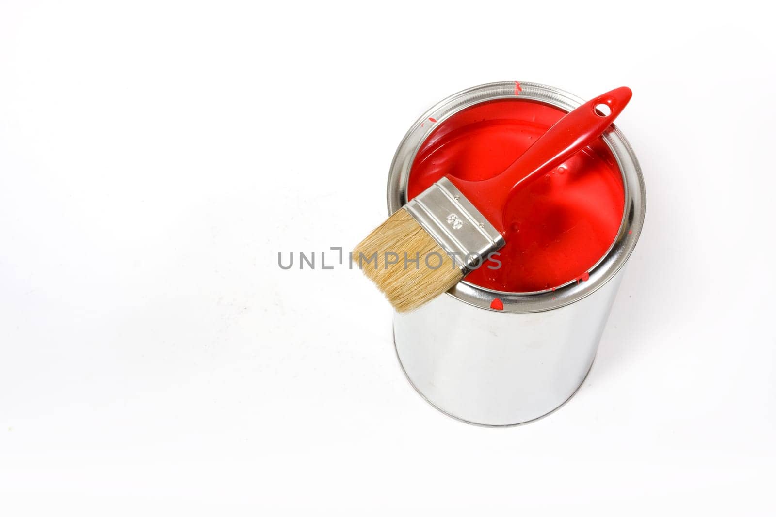 Red paint can with brush isolated