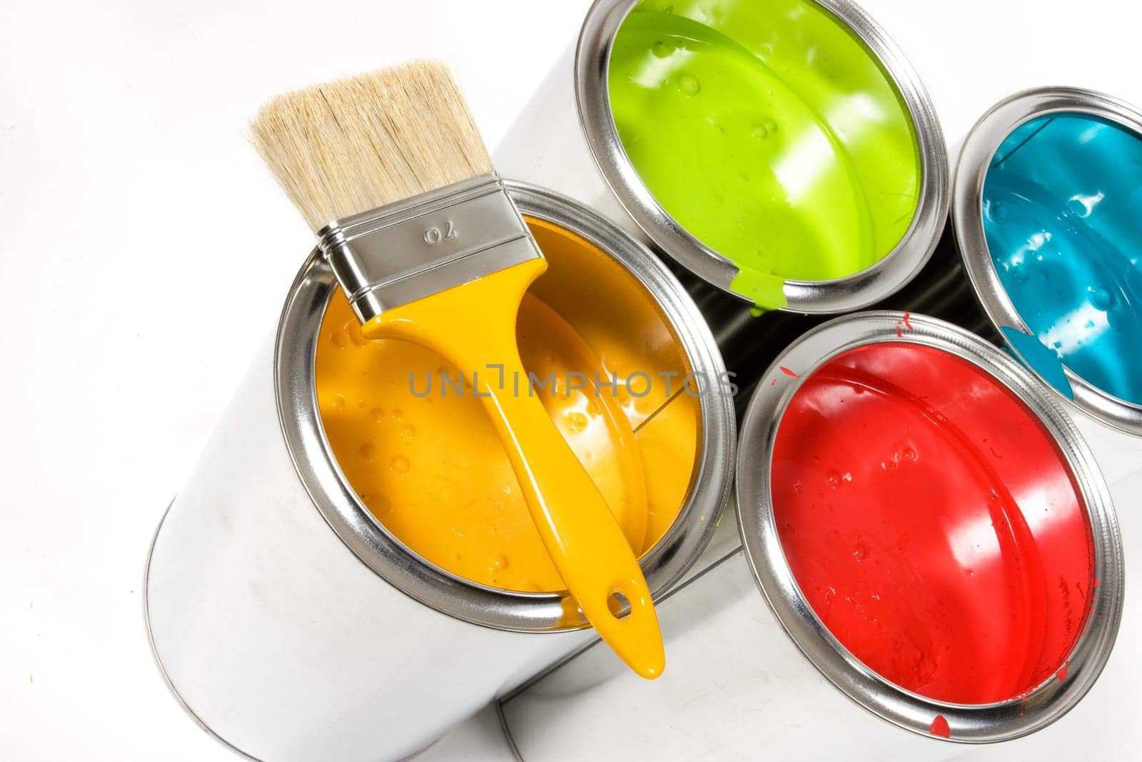 Opened paint buckets with paintbrush