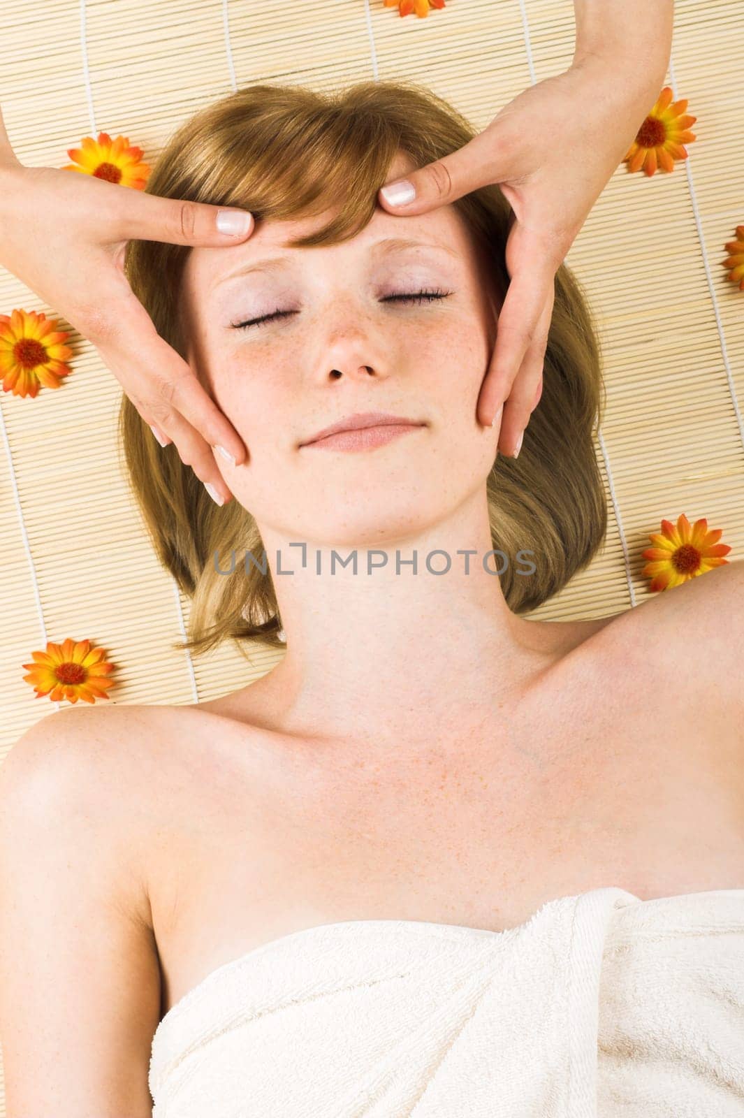Relaxed woman at spa with flowers