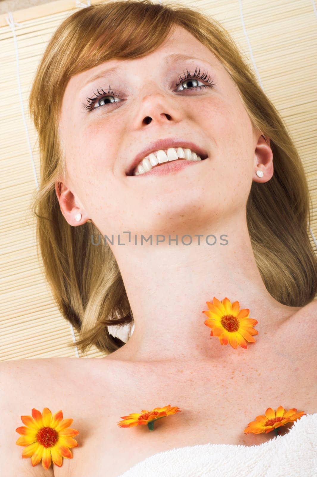 Young woman at spa with flowers