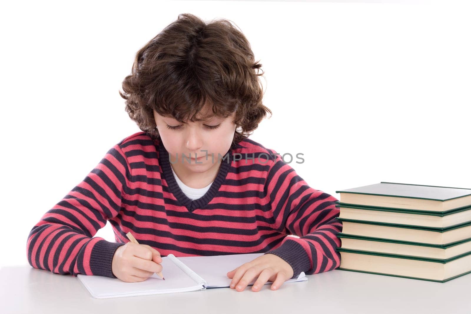 Adorable child writing in the school