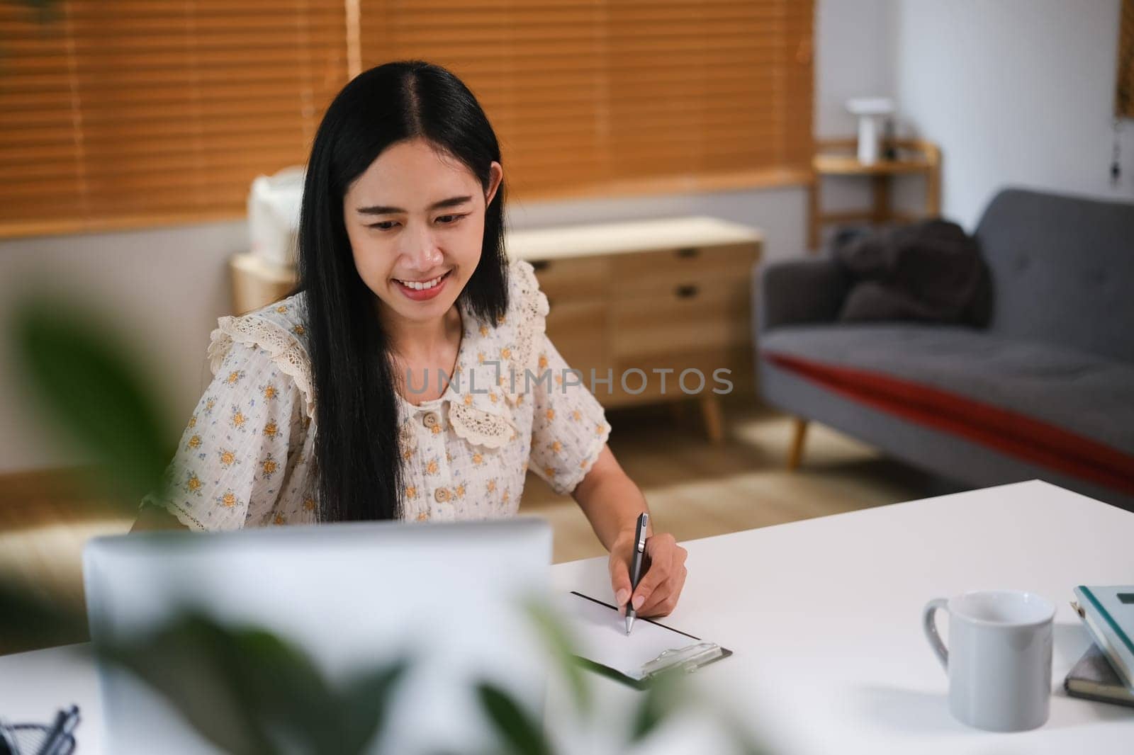 Beautiful woman using laptop at home, sending email or browsing internet. People and technology concept.