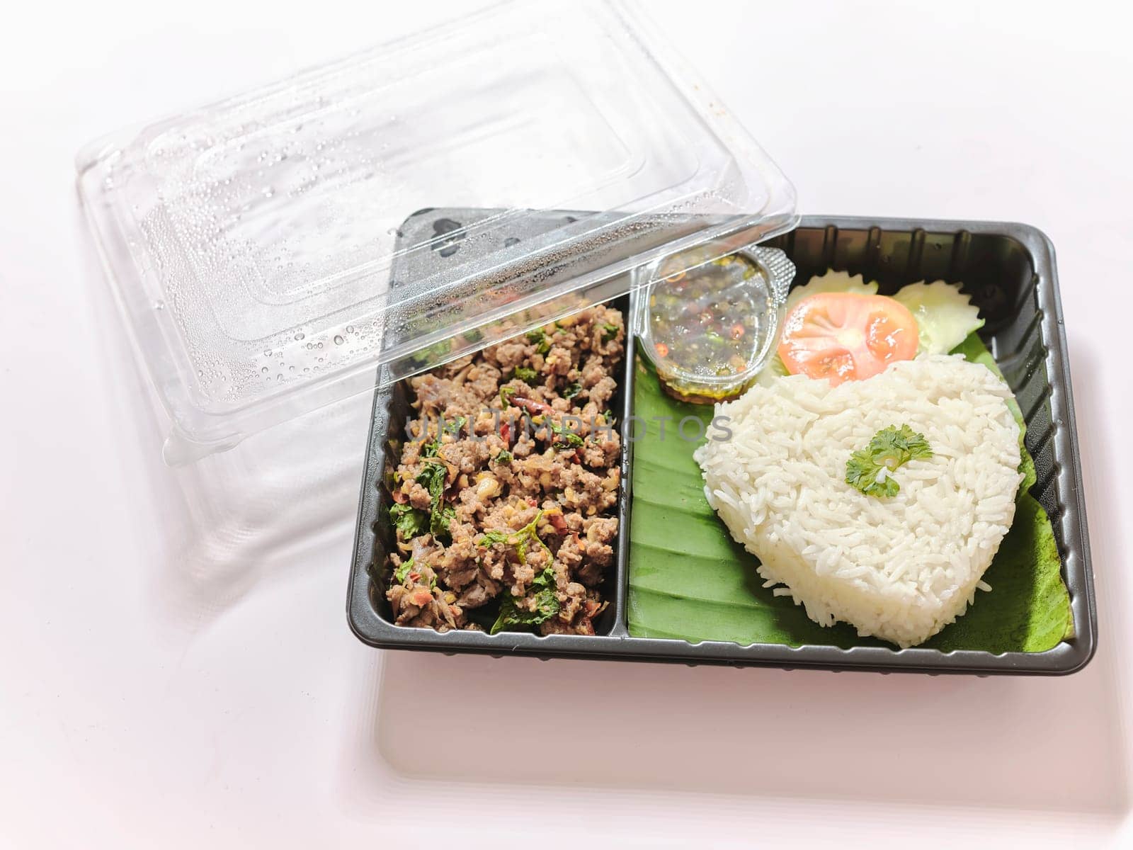 Basil fried rice with pork in plastic box at street market  by Hepjam