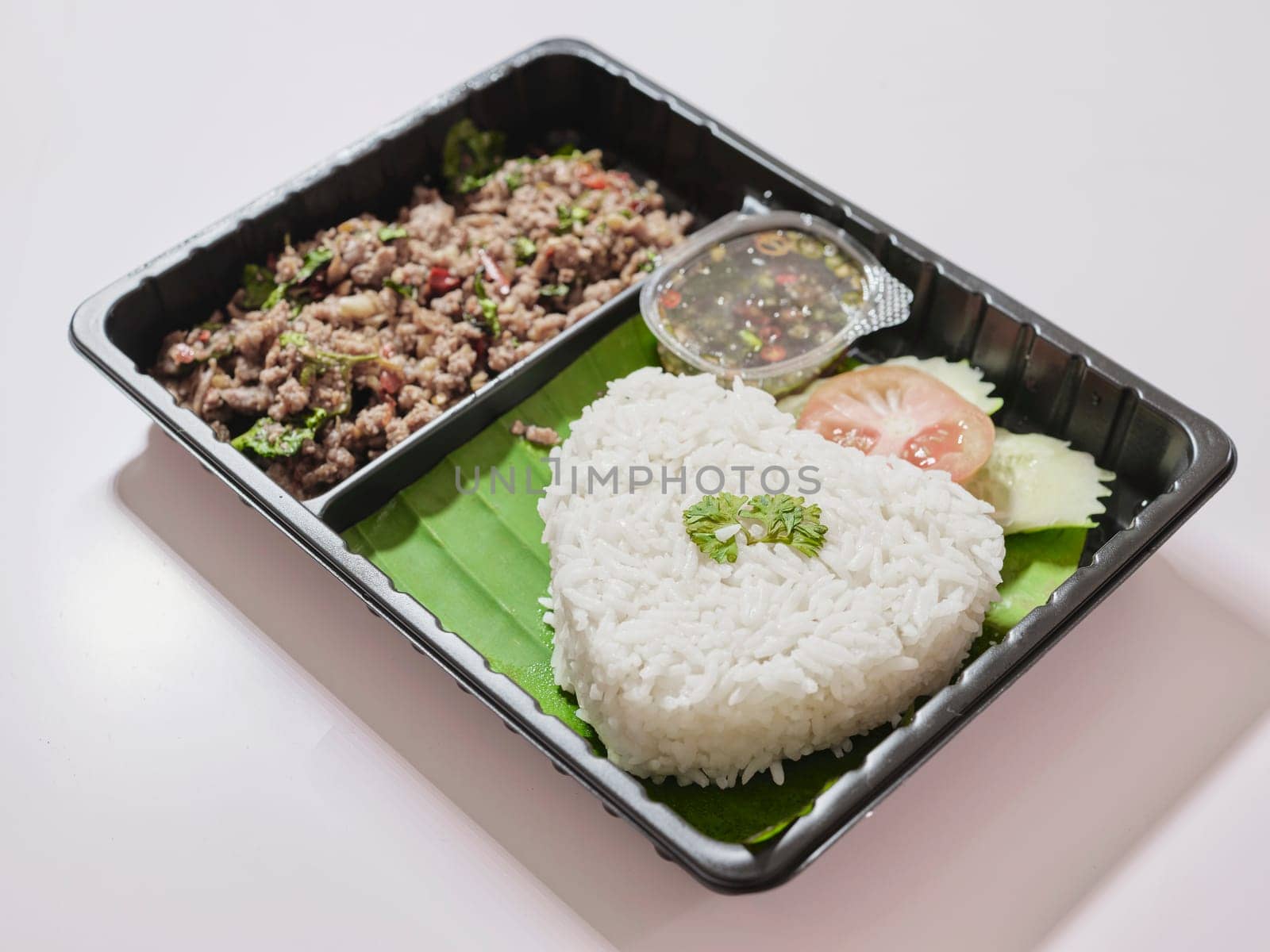 Basil fried rice with pork in plastic box at street market  by Hepjam