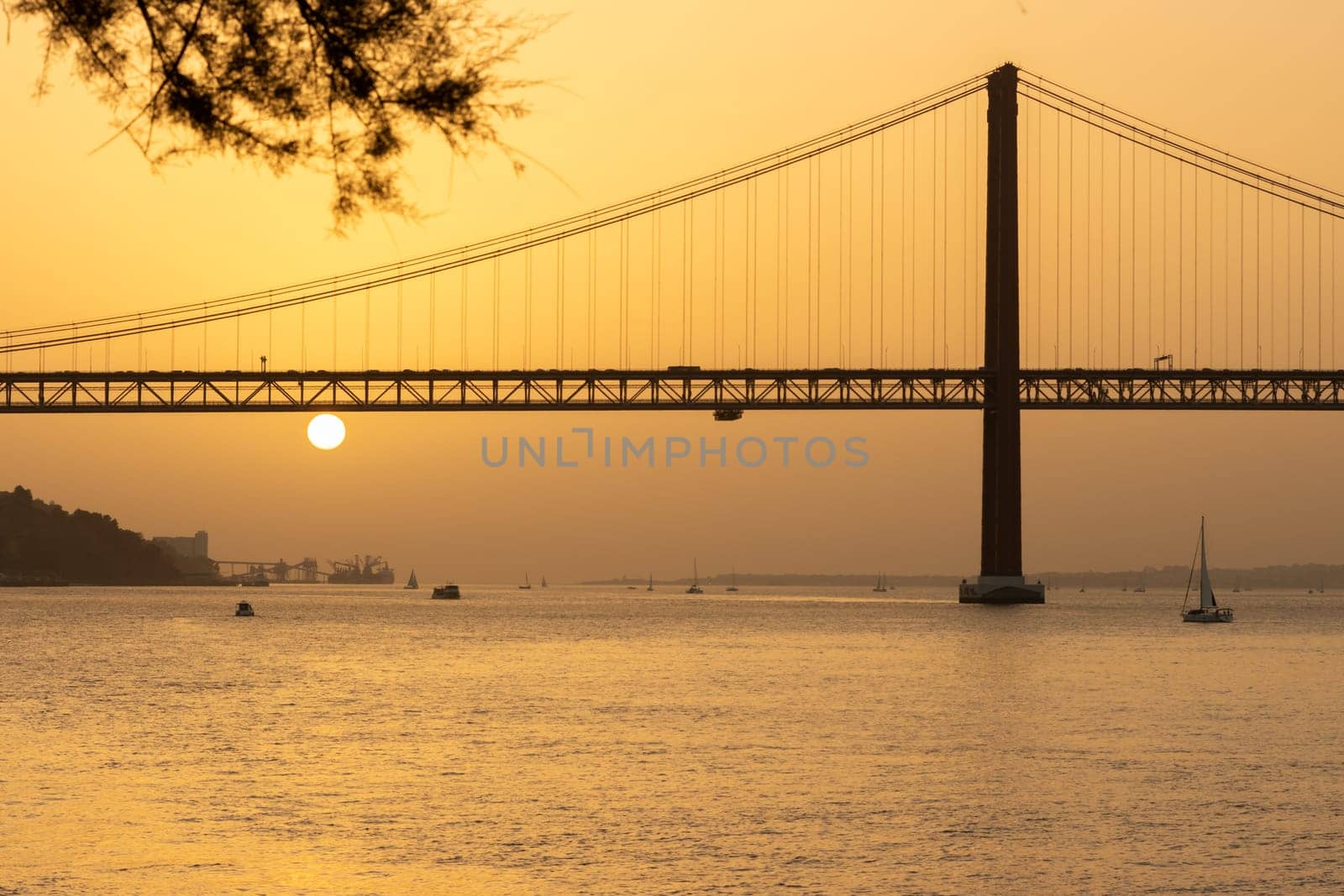 25th of April Bridge - Sunset over Tagus river in Lisbon. Mid shot