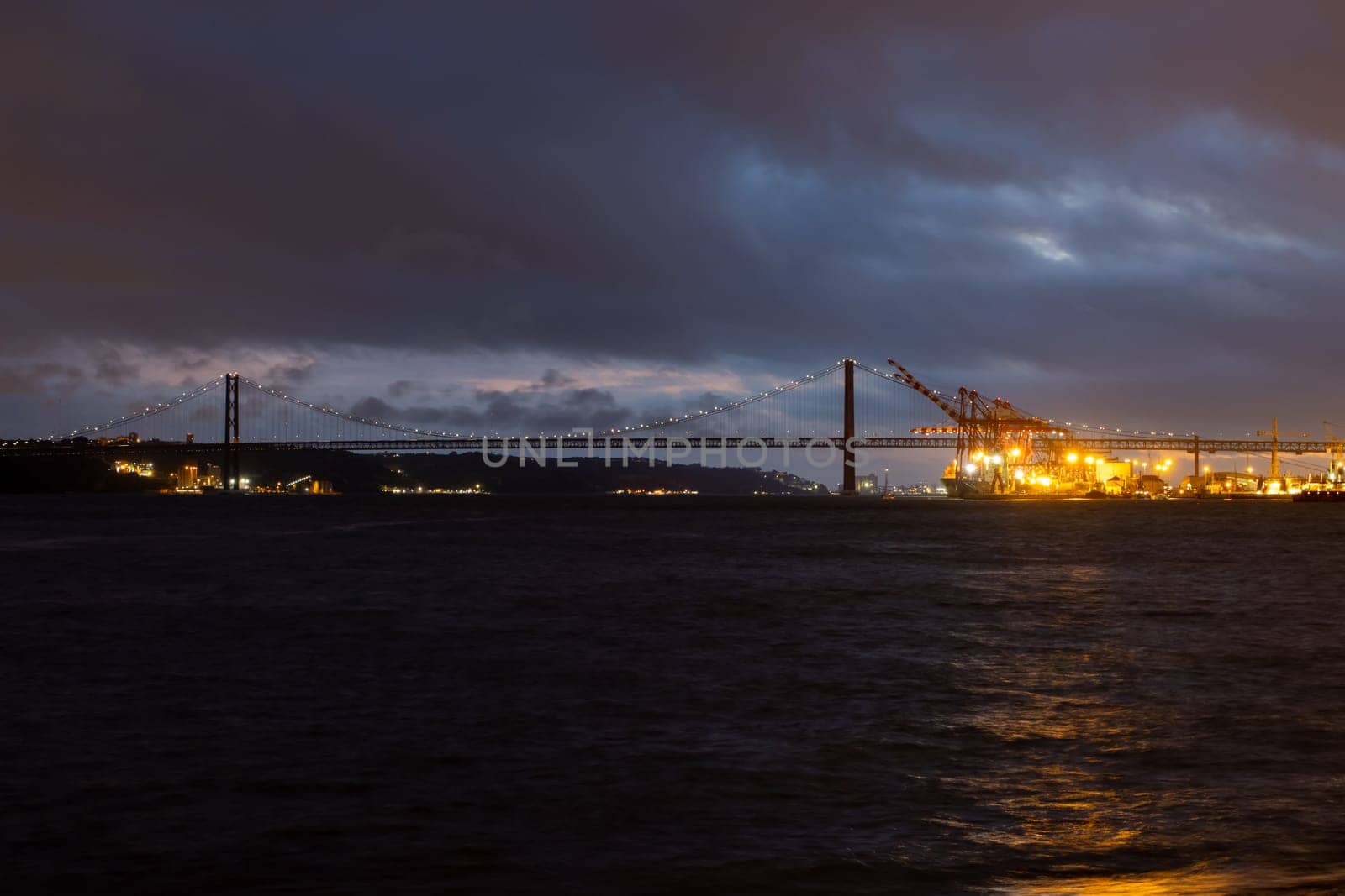 Night view of Tagus river and 25th of april bridge - Landscape. Mid shot