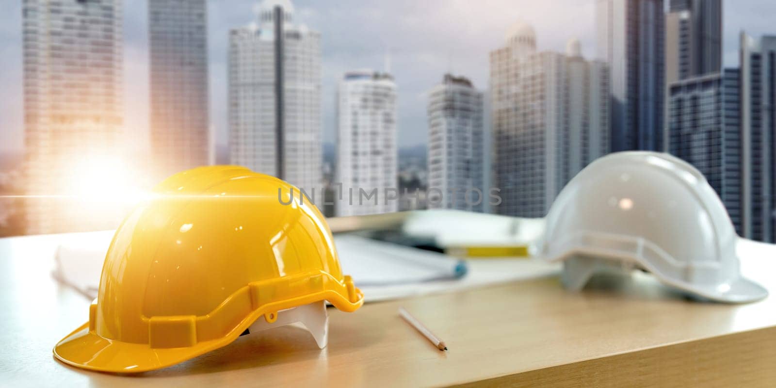 Yellow white safety helmet on workplace desk office center at construction site, contractor concept by nateemee