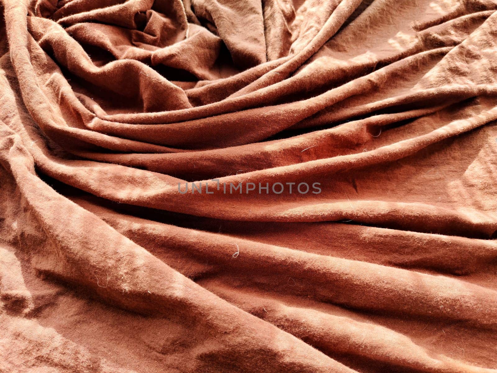 Abstract background and texture of crumpled brown fabric. Texture, pattern, frame and copy space