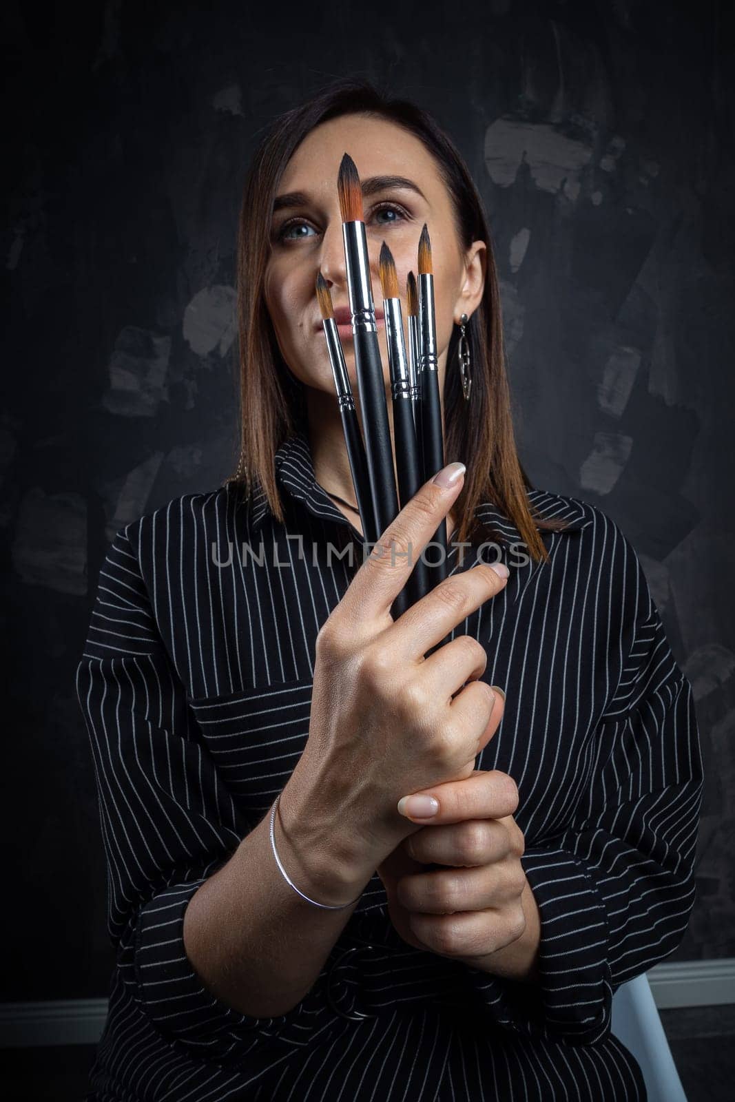 Portrait of a female artist, with brushes in her hands.
 by Evgenii_Leontev