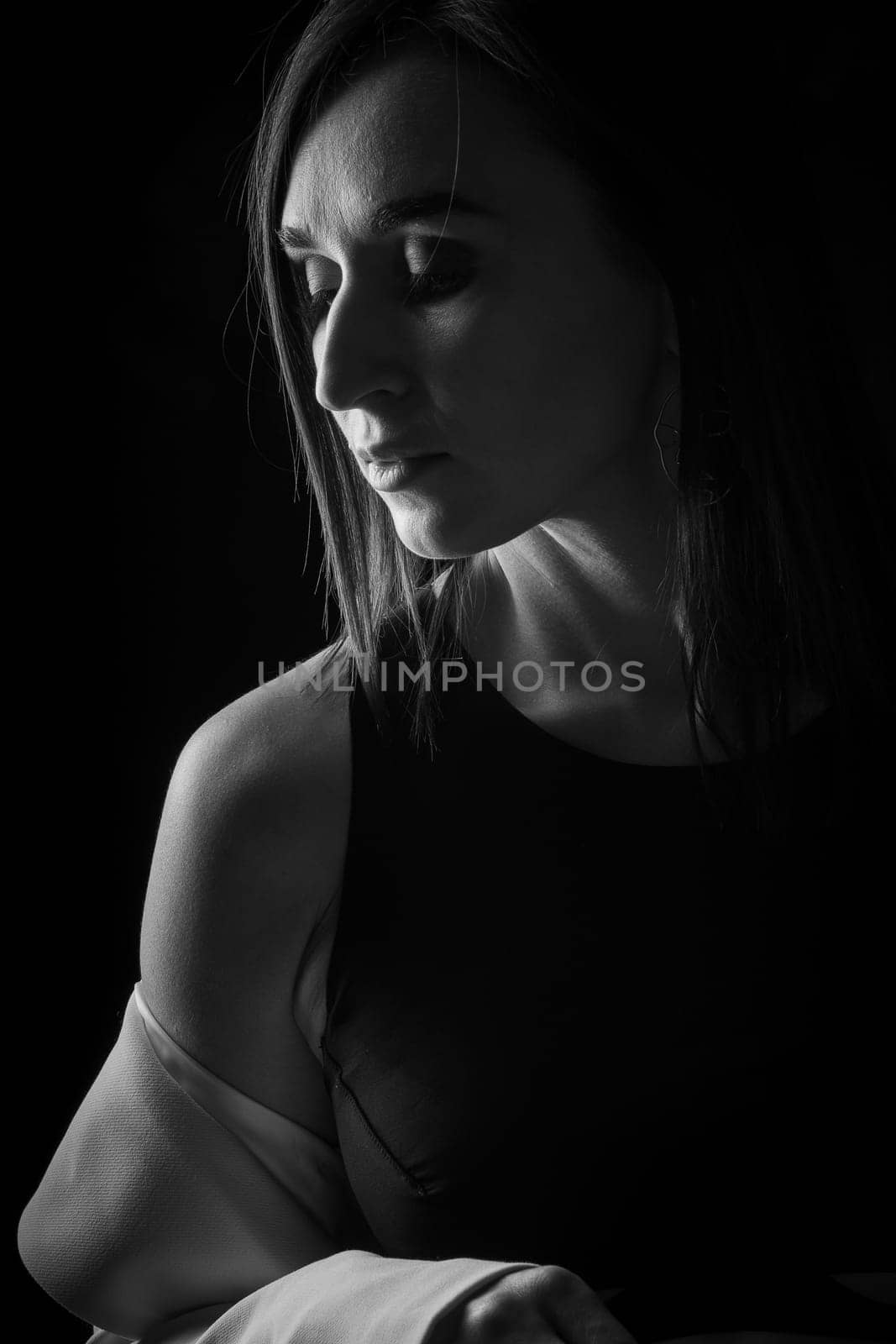 A business woman showing off her body in her underwear. Shot in the studio on a dark background.