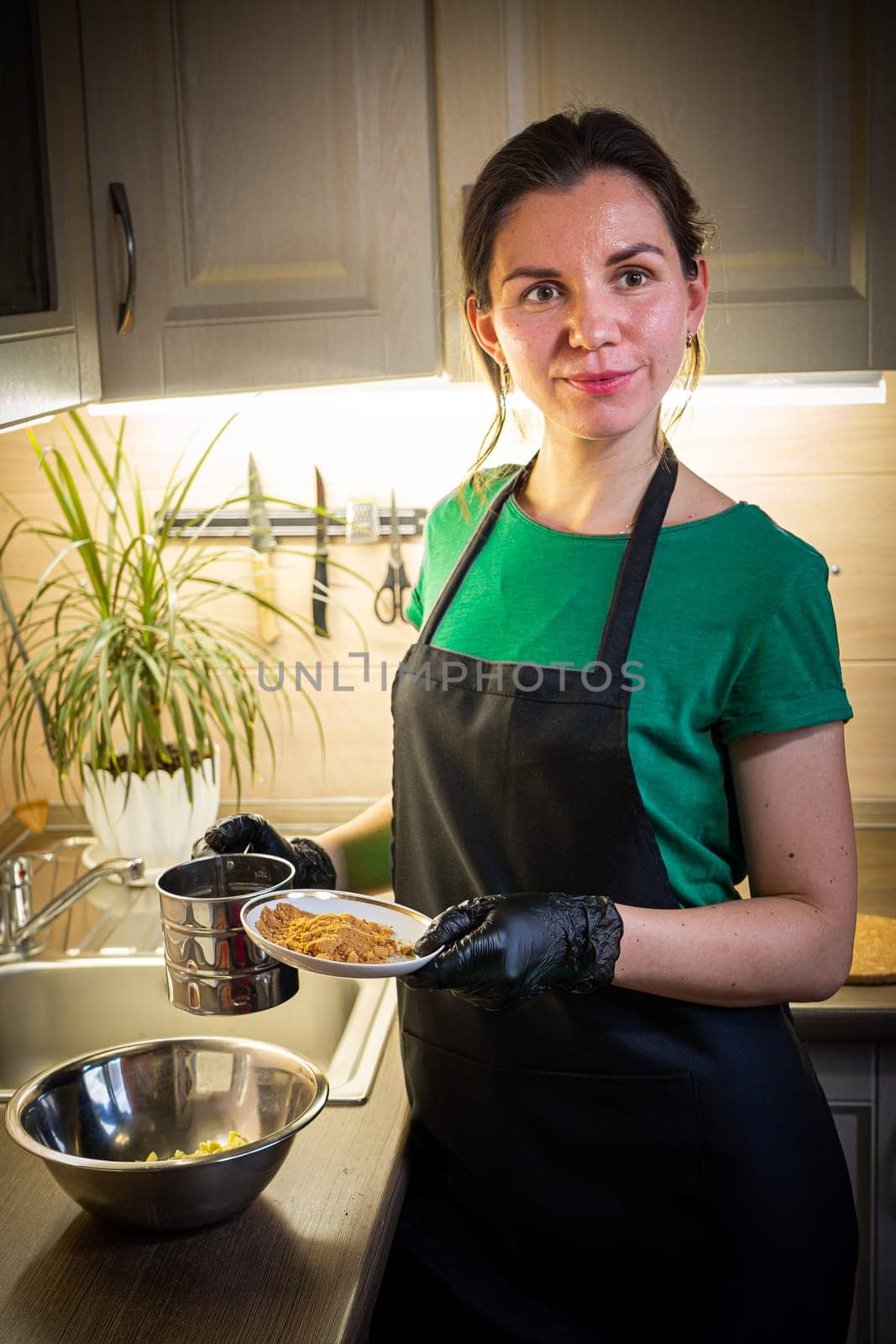 Woman cooking tasty melted chocolate on table in kitchen. Delicious dessert made of homemade chocolate.