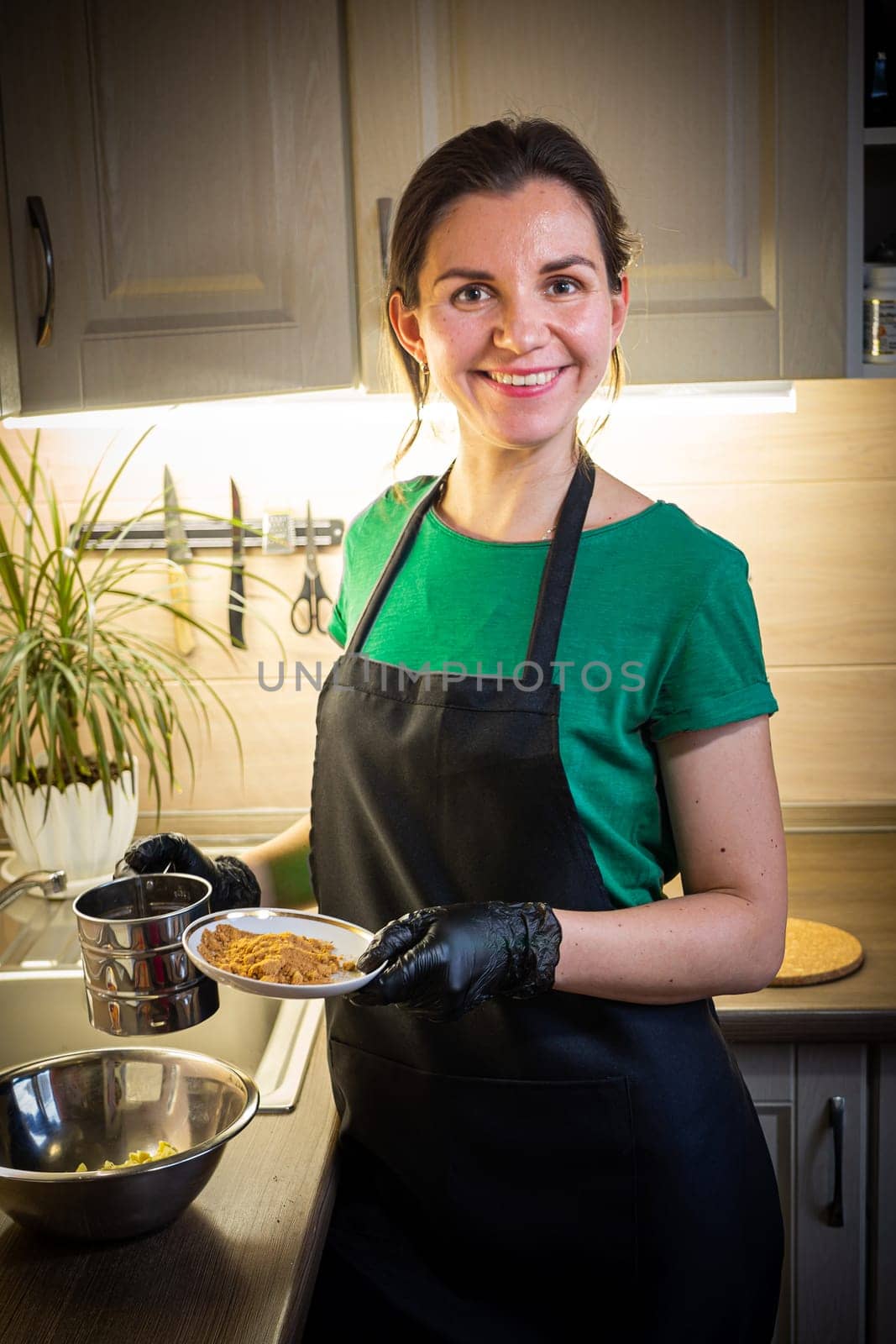 Woman cooking tasty melted chocolate on table in kitchen. Delicious dessert made of homemade chocolate.