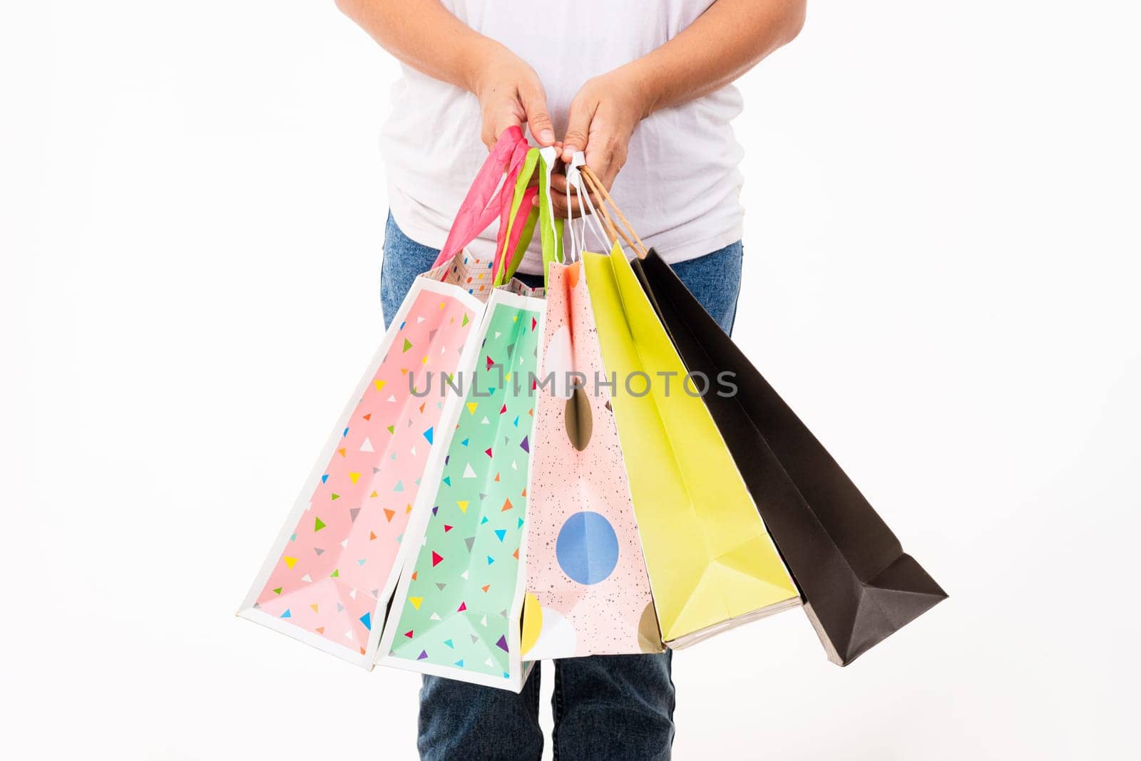 Happy woman hand holding shopping bags multicolor, young female hold many packets within arms isolated on white background, Black friday sale concept