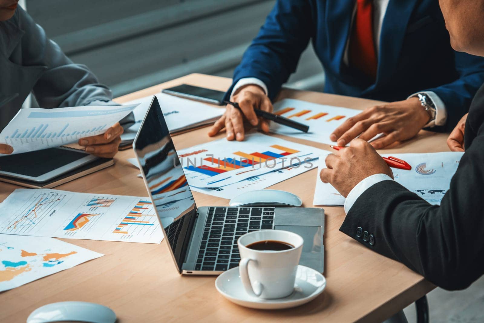 Smart businessman and businesswoman talking discussion in group meeting at office table in a modern office interior. Business collaboration strategic planning and brainstorming of coworkers. Jivy