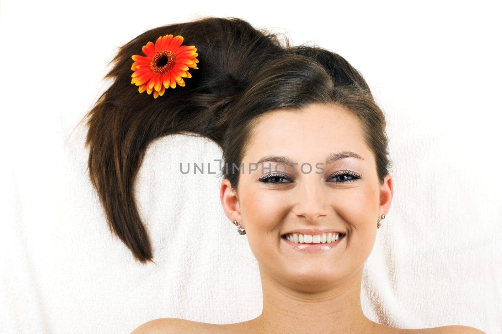 Happy woman at spa with flower