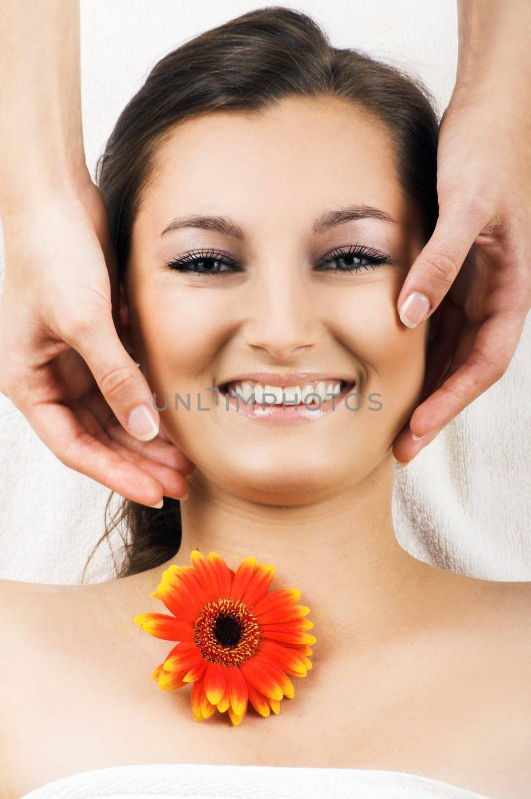 Happy woman at spa with flower
