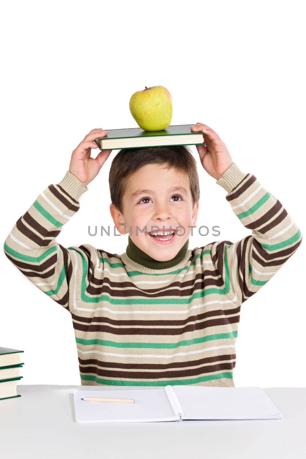 Adorable child studying with books
