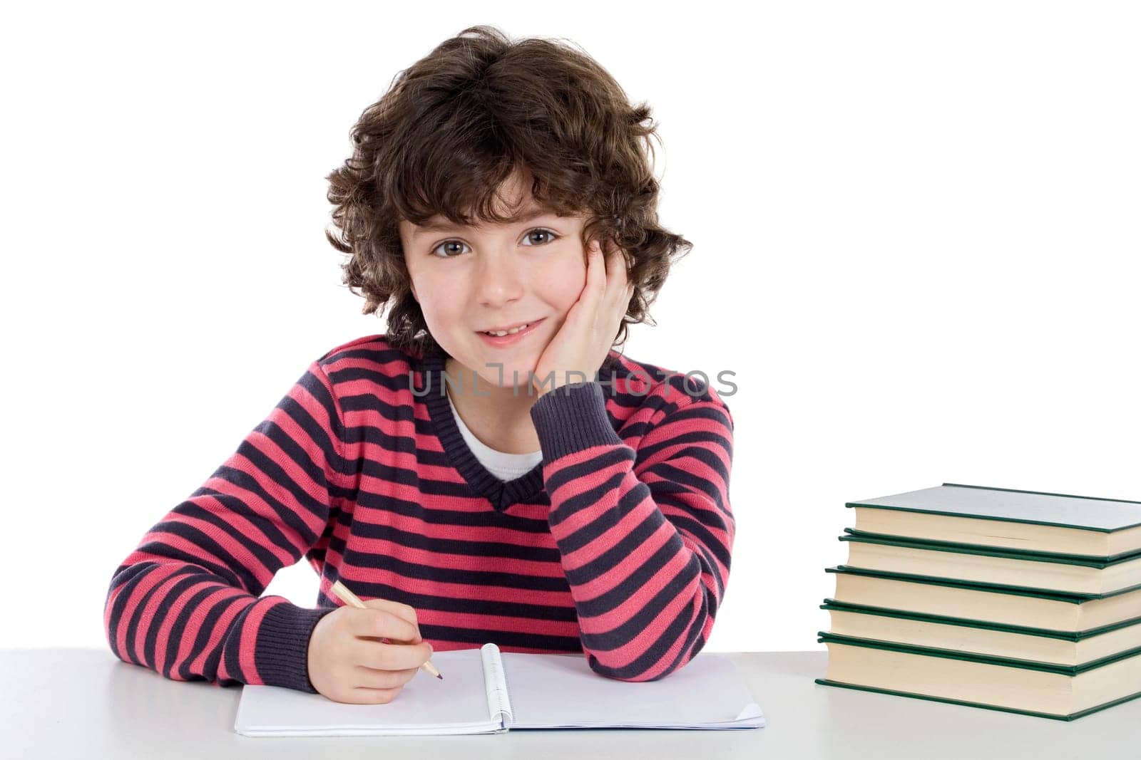 Adorable child writing in the school