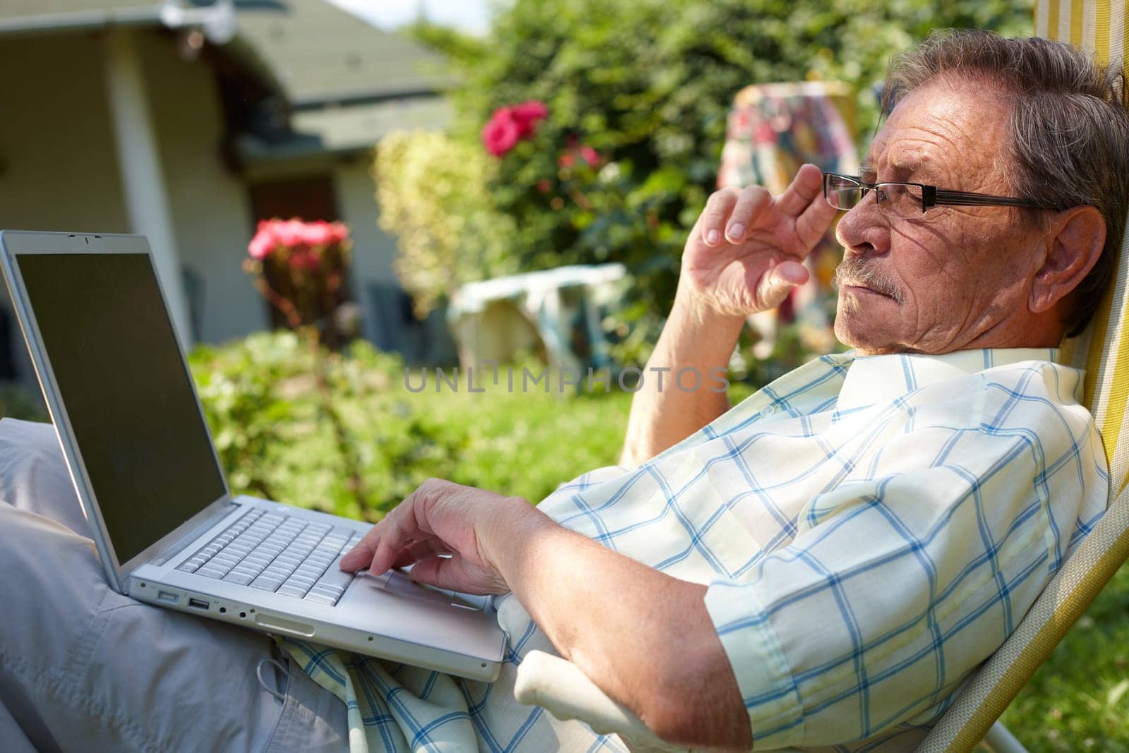 Senior man using computer outdoor