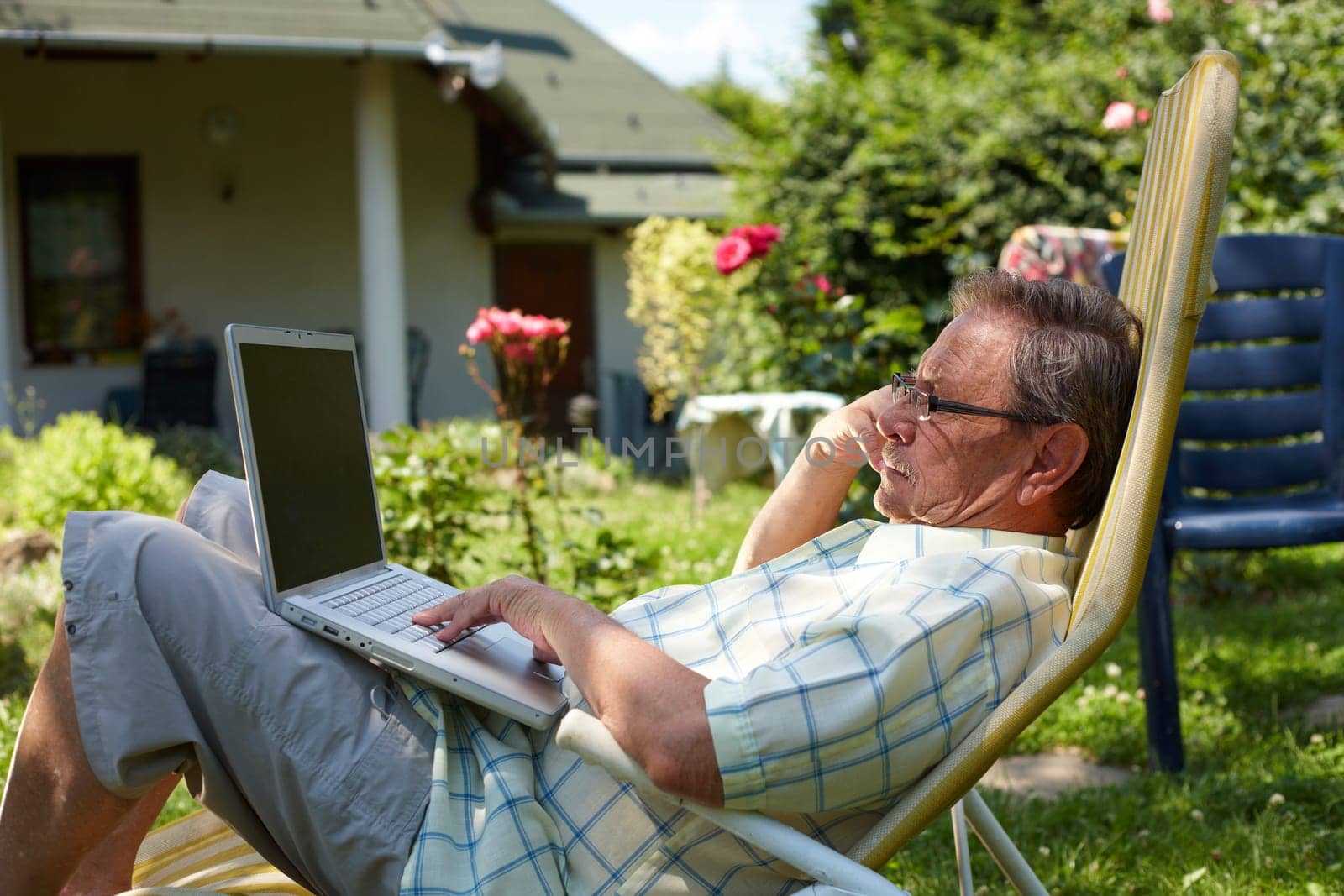Senior man using laptop outdoor