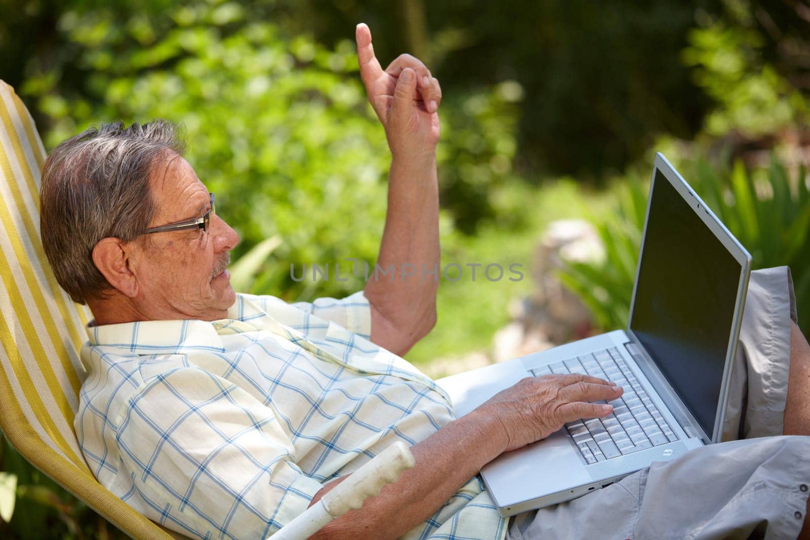 Senior man using laptop outdoor