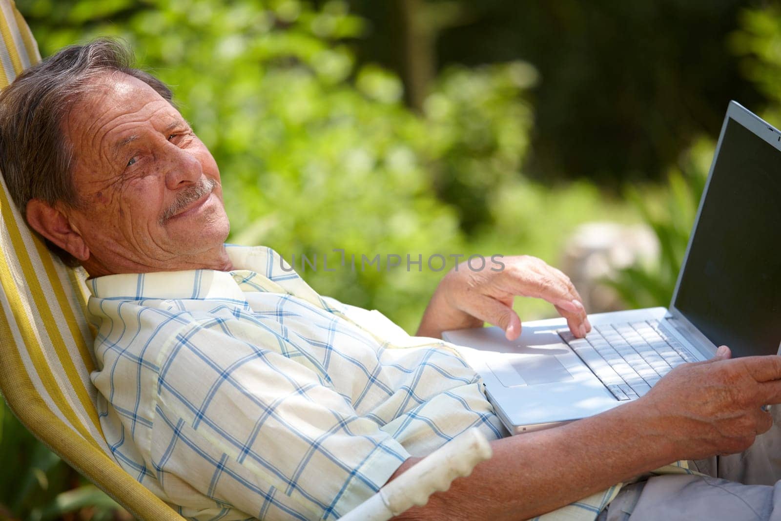 Senior man using laptop outdoor