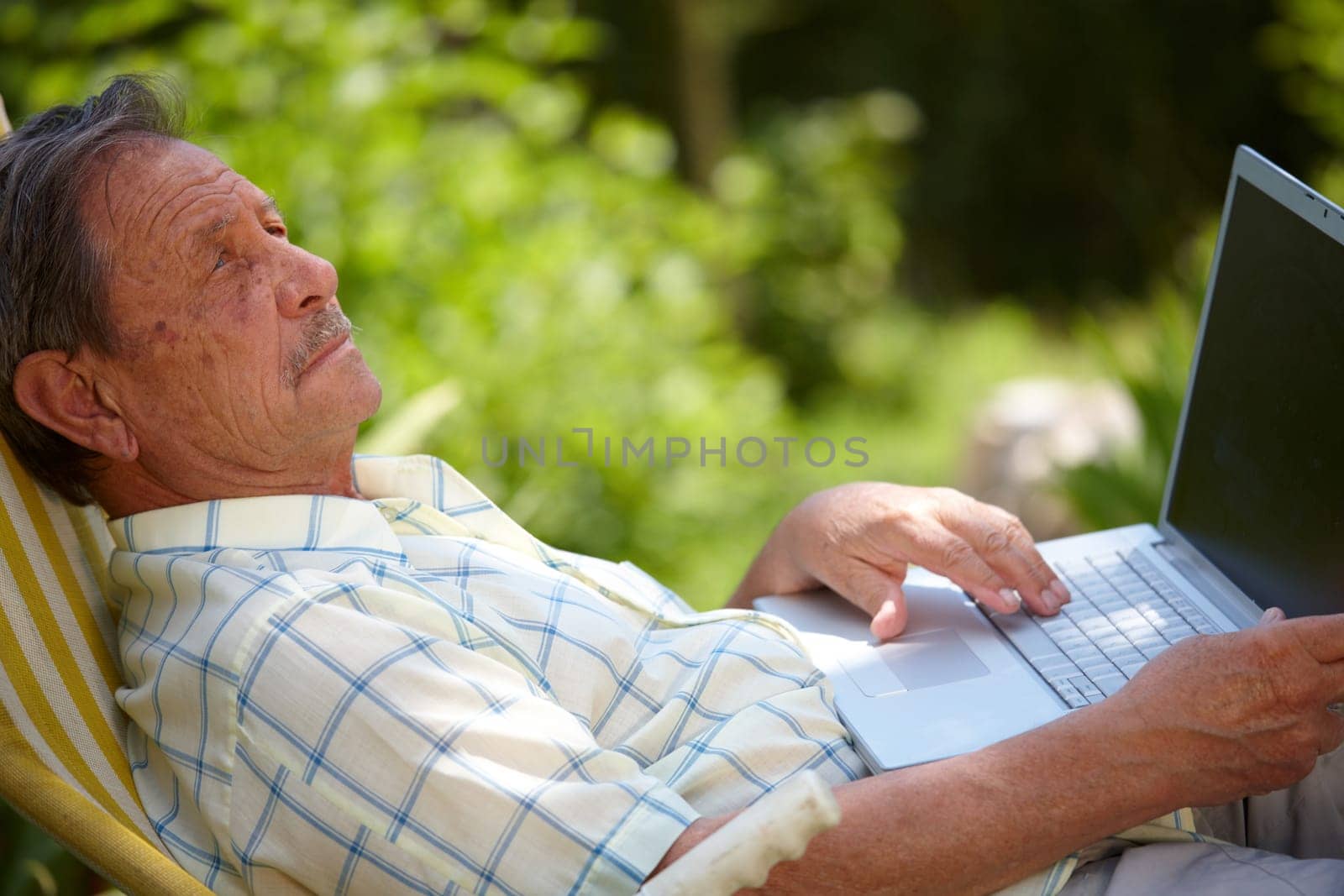 Senior man using laptop outdoor
