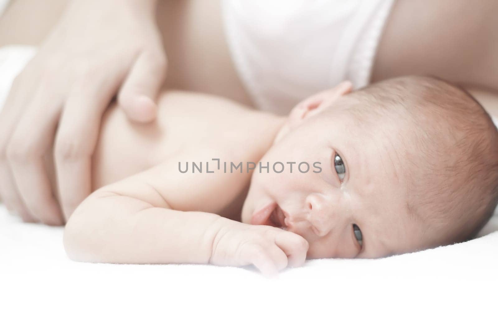 Mother fondles newborn baby