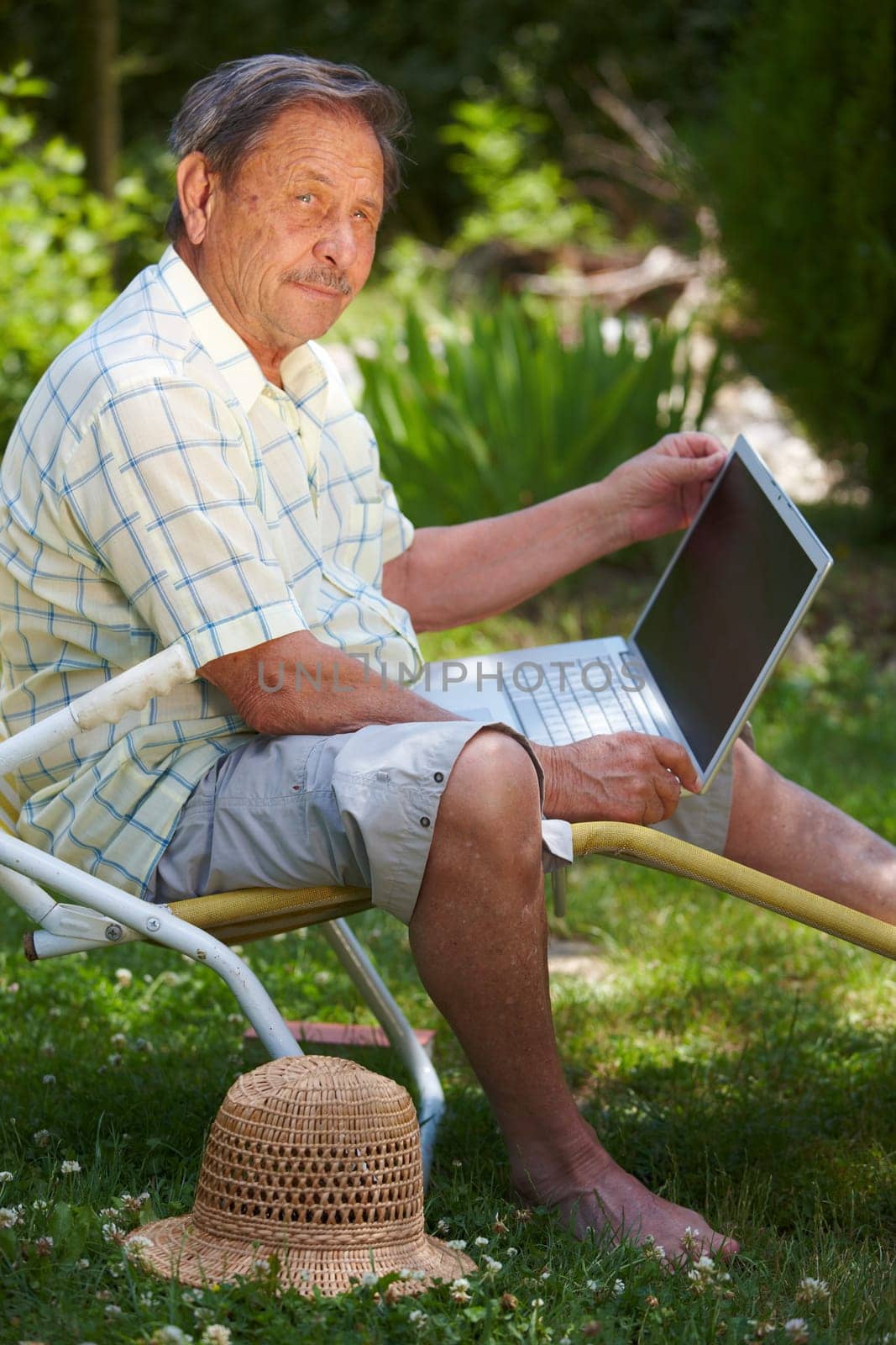 Senior man using computer outdoor