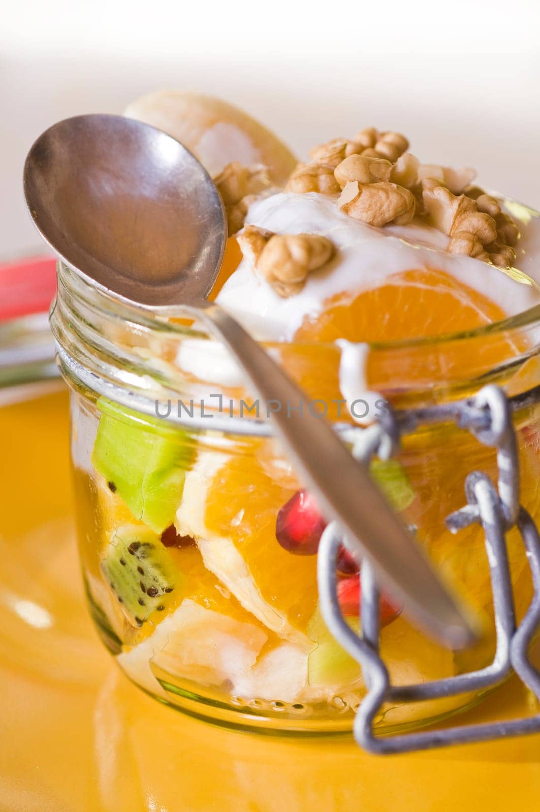 Fruit salad in a mason jar with yoghurt