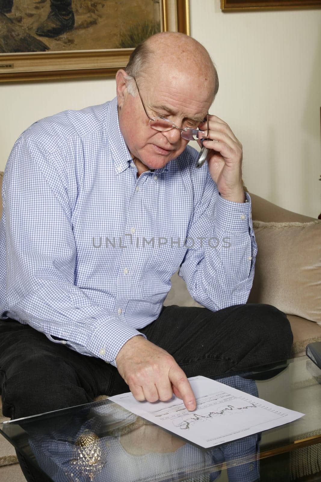 Cheerful senior at home with laptop