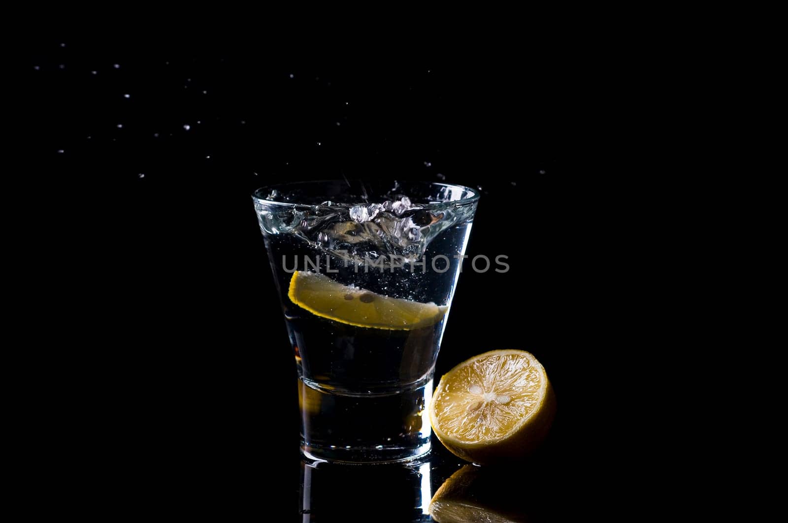 Glass of water against black background