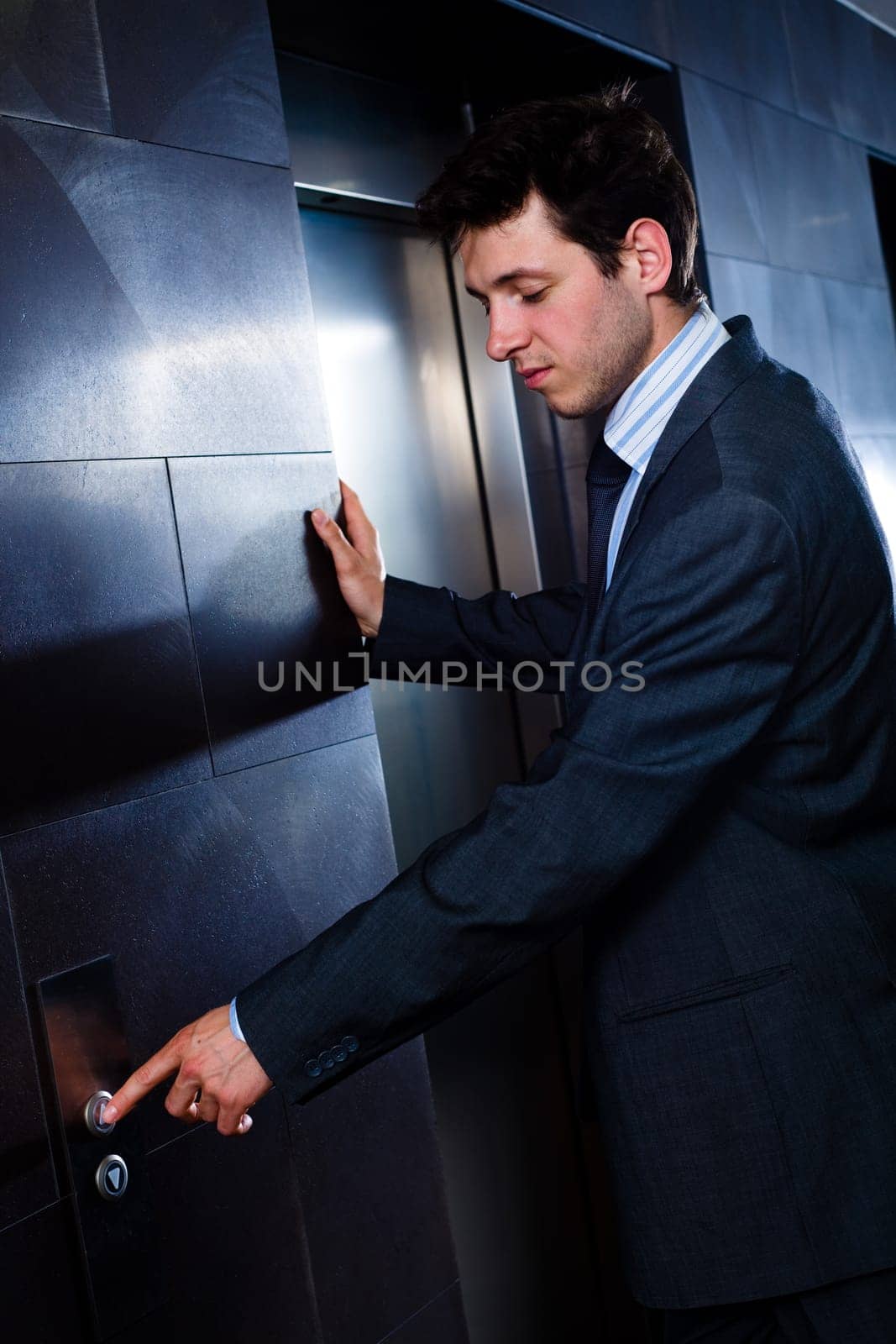 Businessman calling elevator