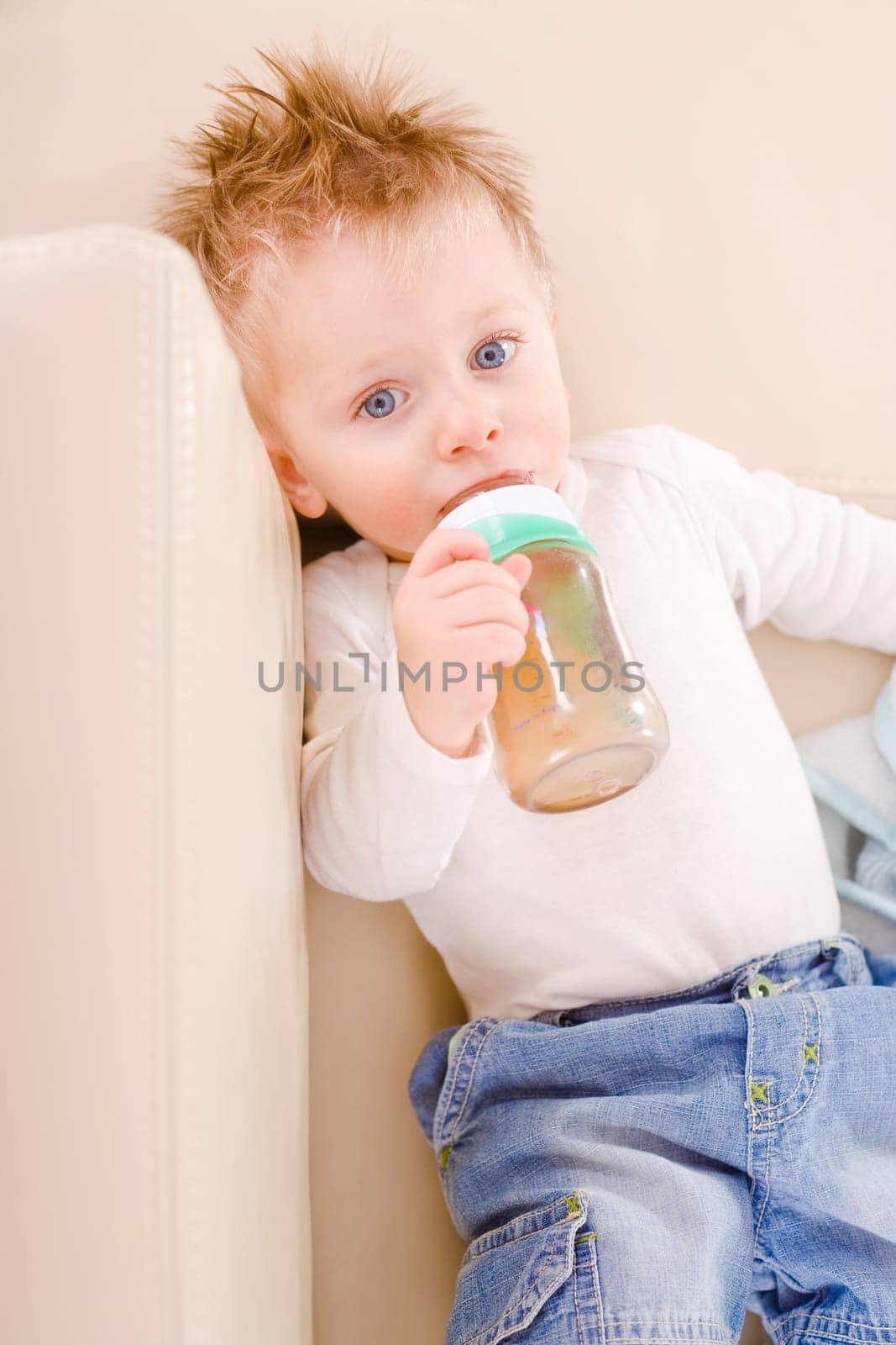 Baby boy drinking from bottle