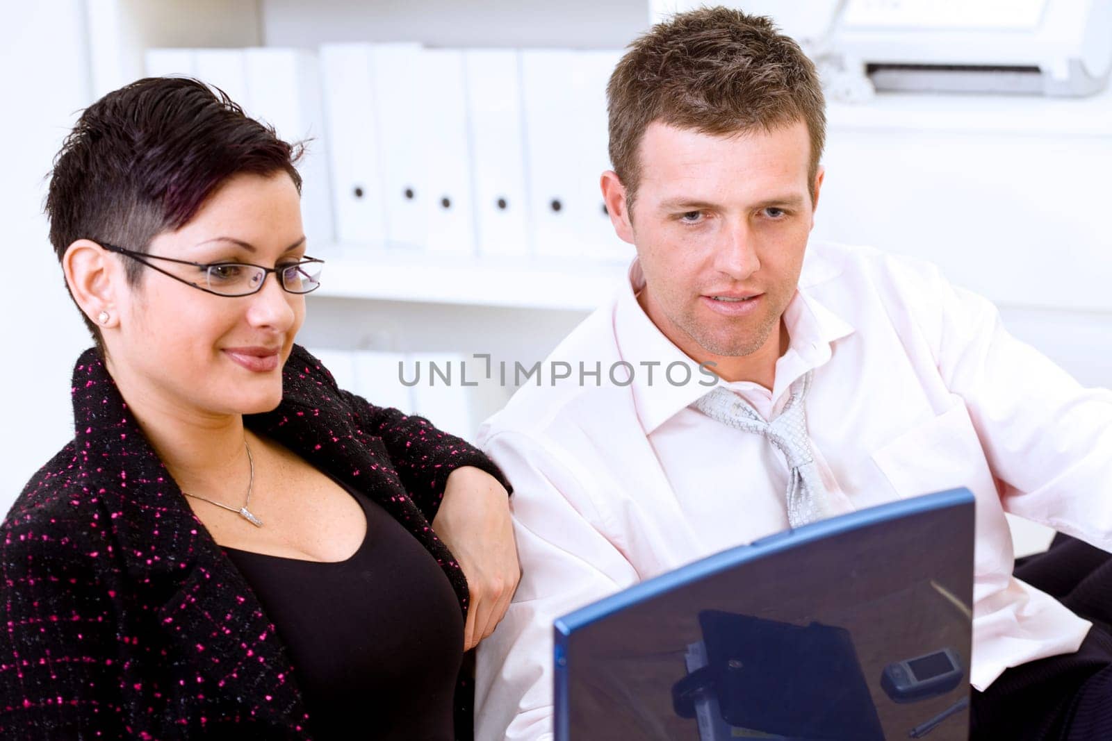 Businesspeople looking at laptop