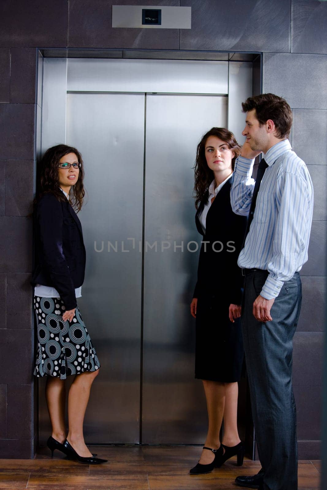 Businesspeople waiting for elevator