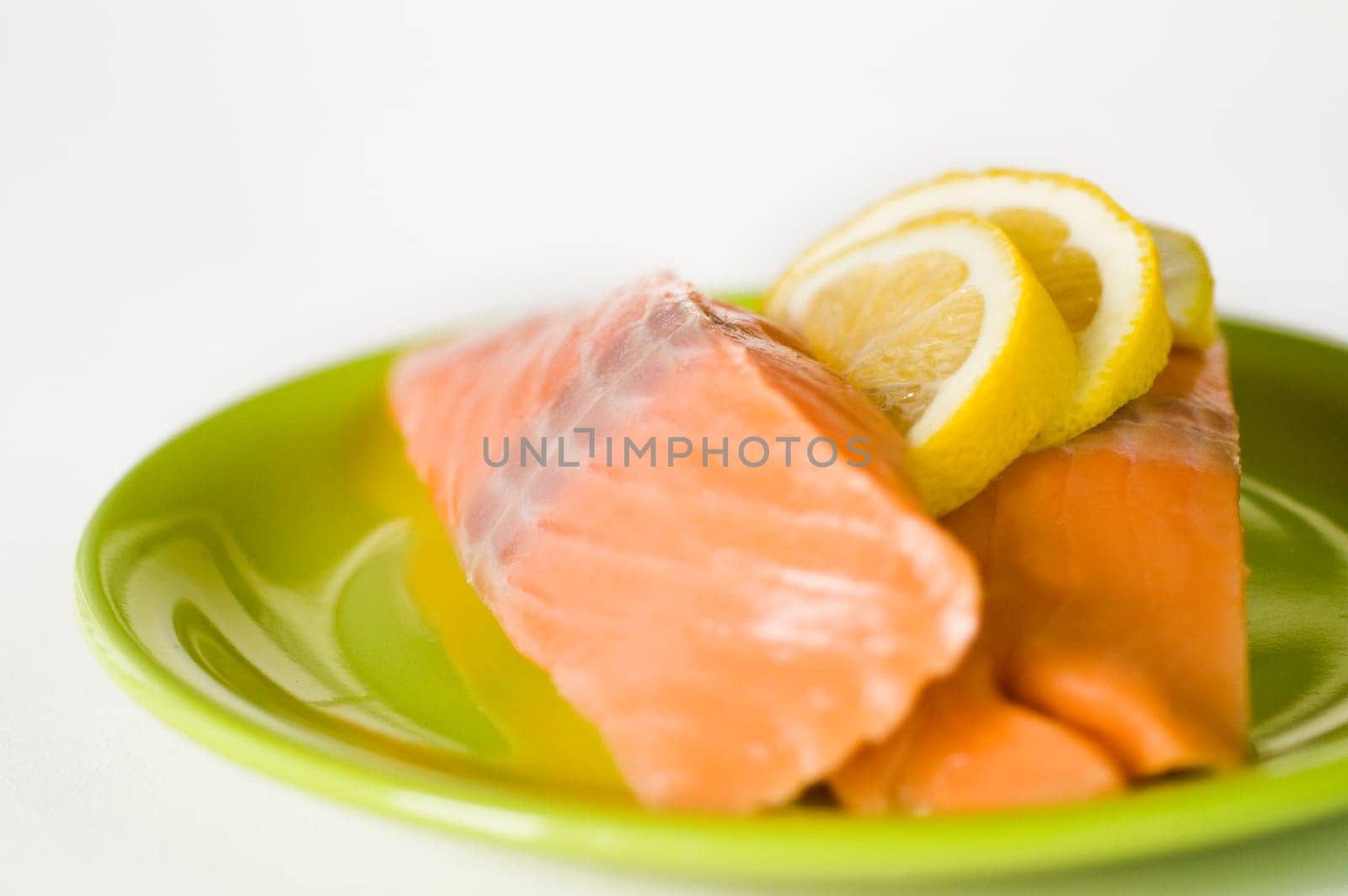 Salmon fillet on green plate