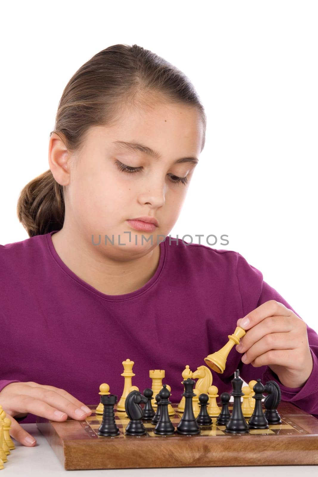 Attractive little girl playing chess
