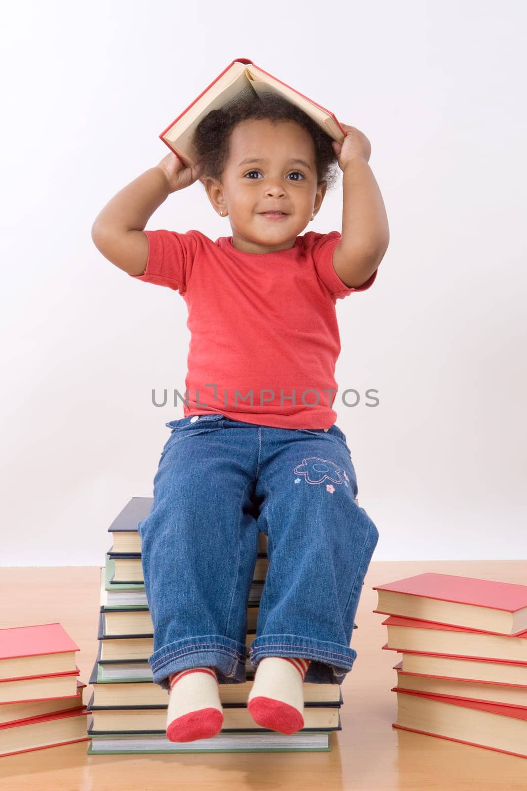 Baby sitting on a pile of books