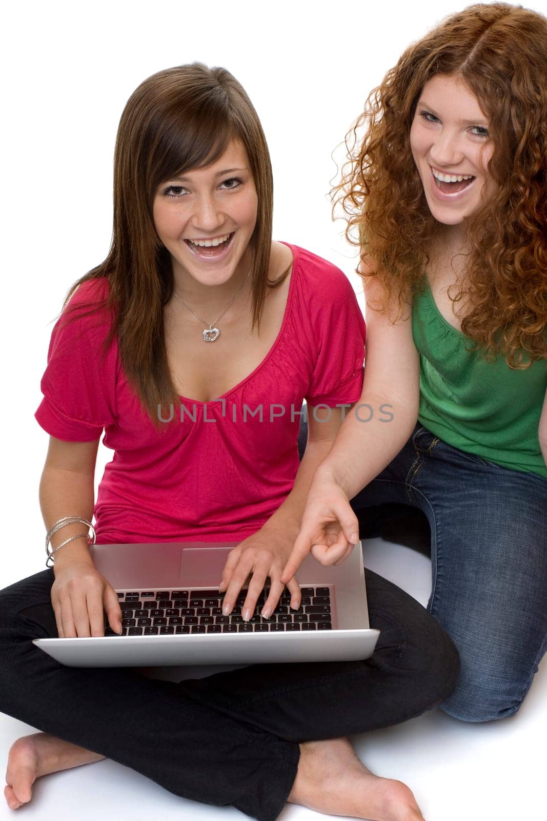 Two teenagers using laptop
