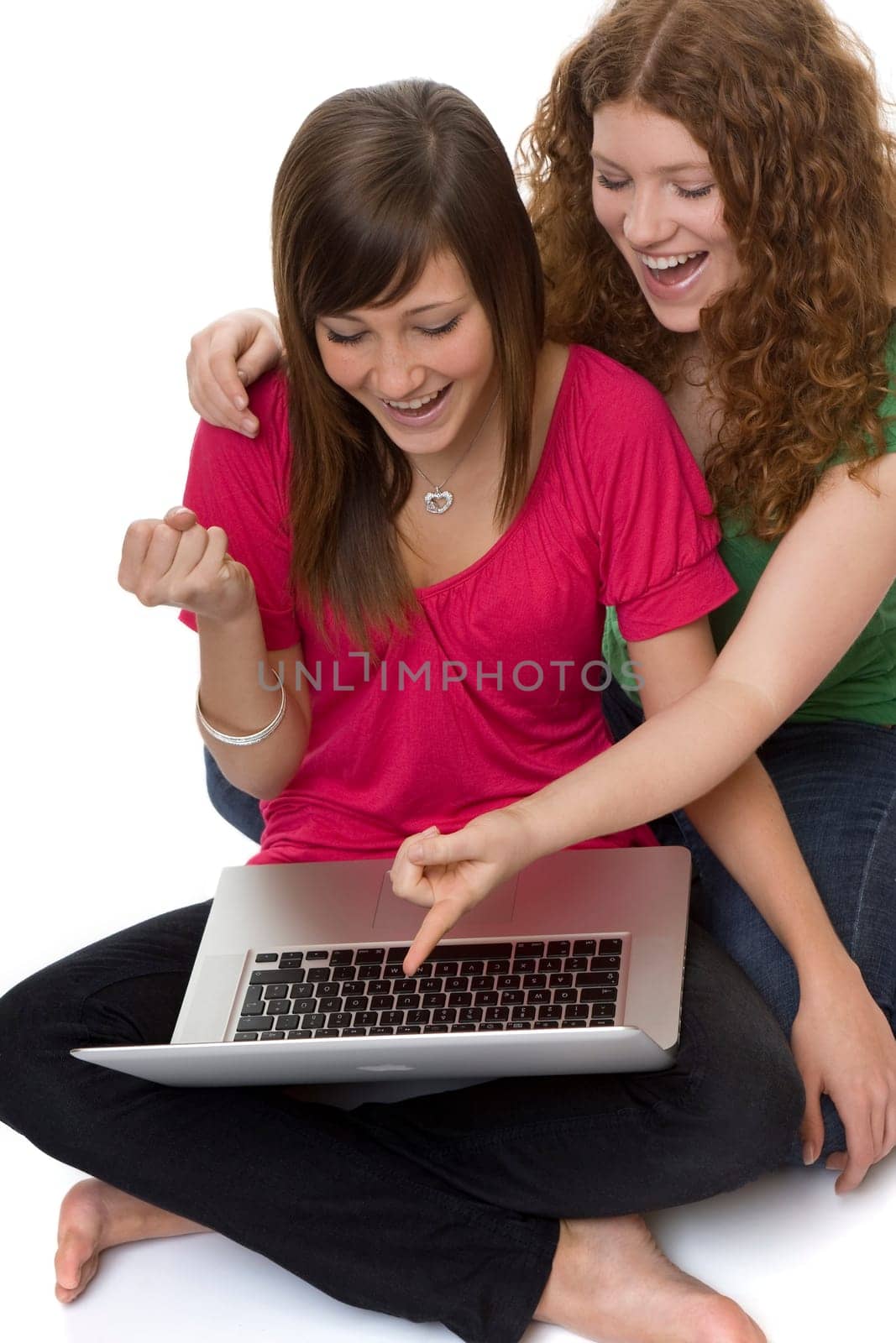 Two teenagers using laptop