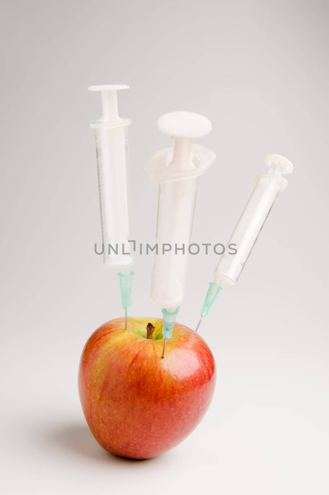 Apple with three syringes