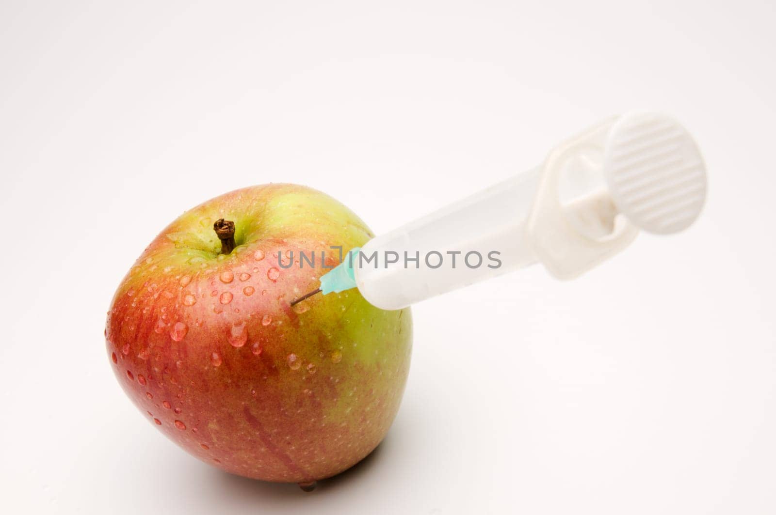 Apple with syringe