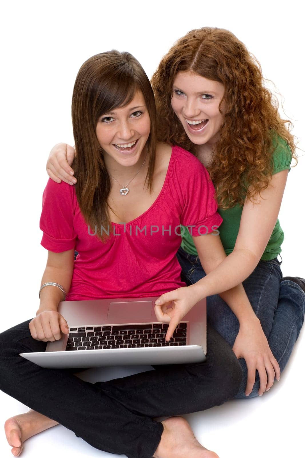 Two teenagers using laptop